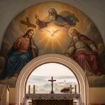 Obraz Jezusa i Boga Ojca w stylu renesansowym namalowany na ścianie kaplicy, pod stołem ze świecami i krzyżem